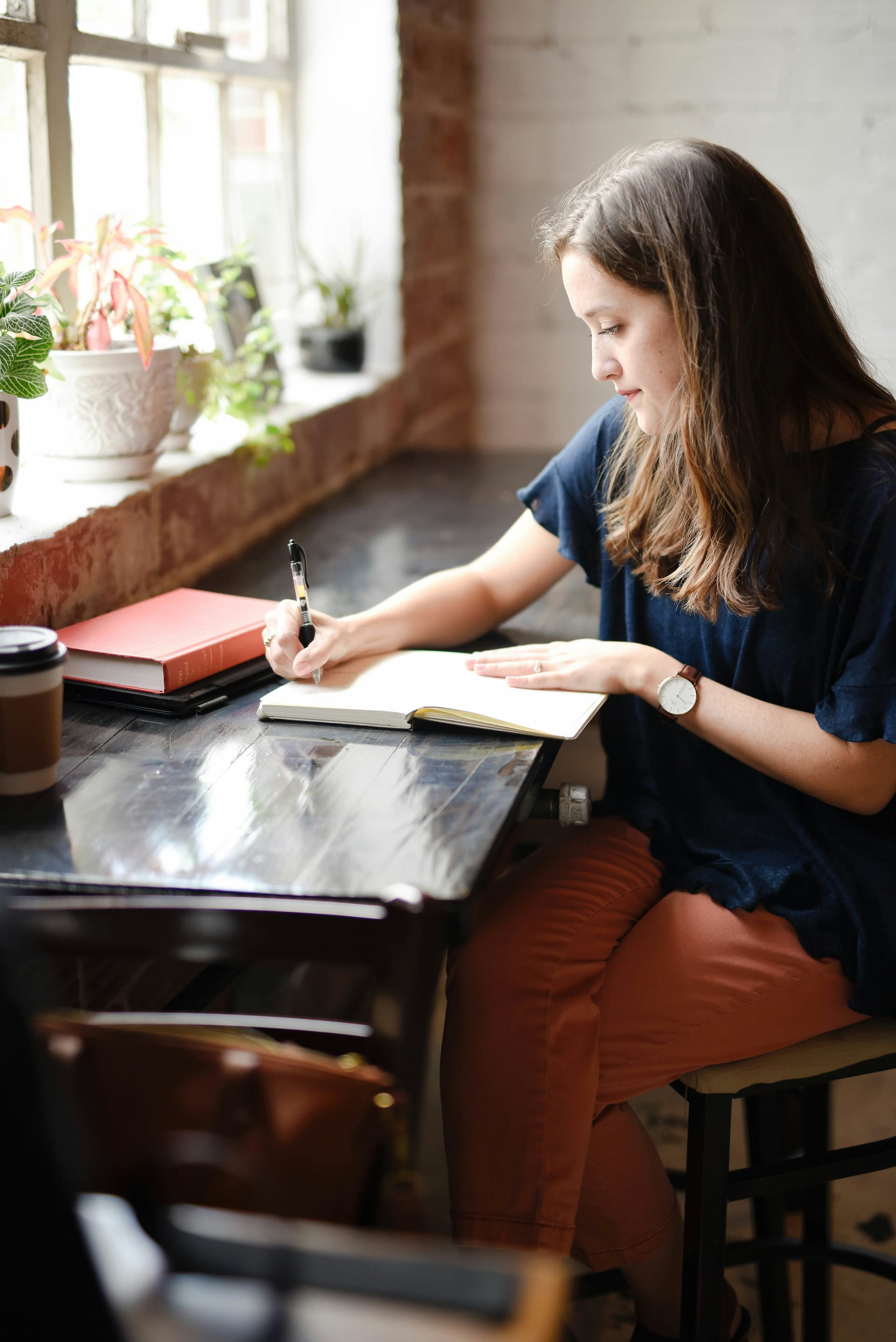 Woman journaling in warm natural light